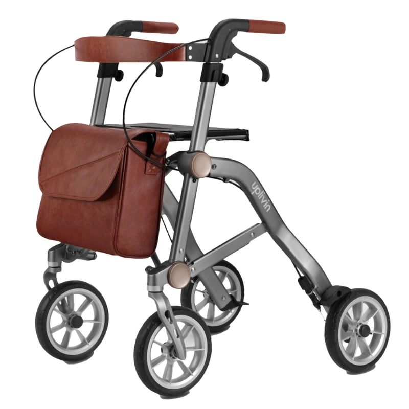 De grijze Trive Rollator afgebeeld op een witte achtergrond. Een lichtgewicht en opvouwbare loopwagen met vier wielen, handremmen en een zitje. Ideaal voor mensen die extra ondersteuning nodig hebben bij het lopen en comfortabel willen rusten tijdens het wandelen.